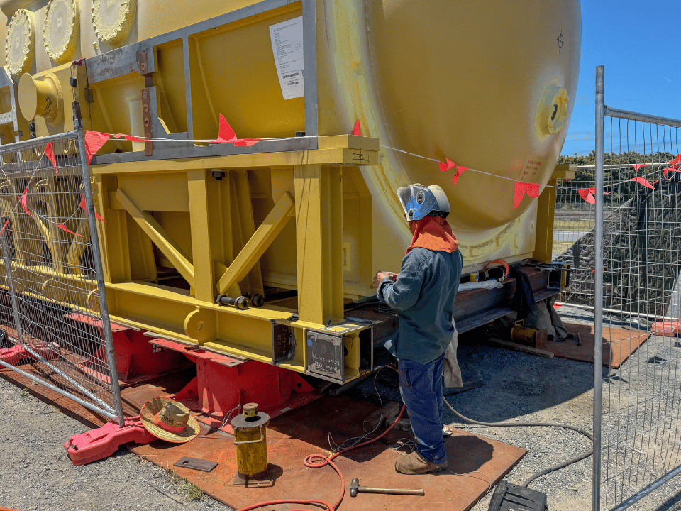 DWW Engineering boilermaker standing in front of generator stator transport frame