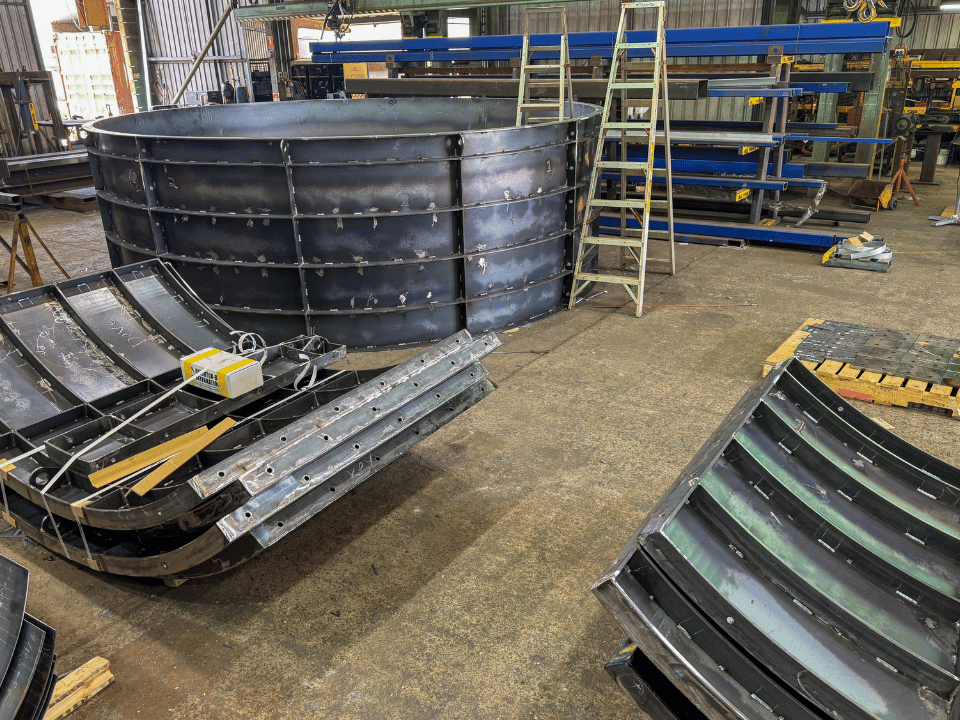 Stacked steel formwork sections ready for installation or transport