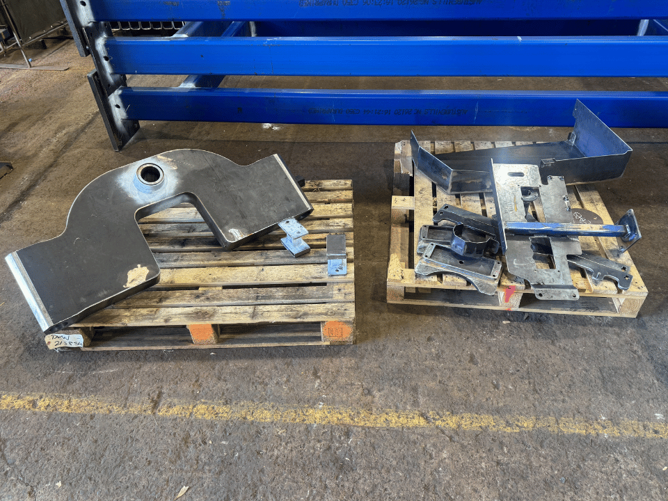Mining liner handler fabrication showing fabricated steel plates, brackets and structural components prepared for assembly at DWW Engineering