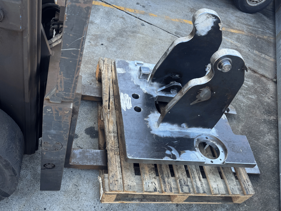 Mining liner handler fabrication showing a fabricated structural steel pivot and mounting assembly prepared for machining.