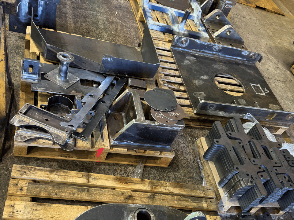 Mining liner handler fabrication showing fabricated steel plates, brackets and cut components prepared for assembly at DWW Engineering