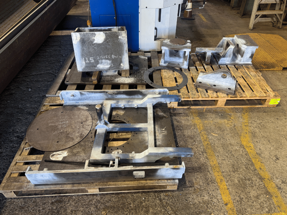 Mining liner handler fabrication showing fabricated steel brackets, frames, plates and support components prepared for assembly at DWW Engineering.